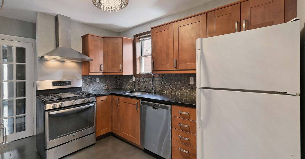 010-Kitchen-With-Stone-Countertops-and-Tile-Backsplash.jpg